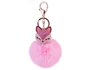Detail of rose gold fox keychain with pink rhinestones, pearls, and a fluffy pompom