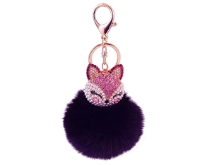 Detail of rose gold fox keychain with pink rhinestones and a purple fluffy faux fur pompom
