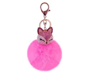Close-up of pink fluffy fox keychain with sparkling crystals and imitation pearls