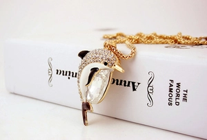 Macro shot of dolphin pendant with white rhinestones and large teardrop crystal