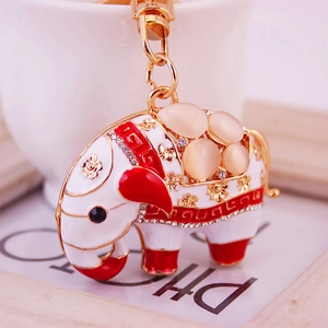 Porte-clés éléphant mignon avec motif floral en émail blanc et strass en cristal