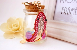 Close-up of a sparkling shark keychain with colorful rhinestones and gold metal lobster clasp