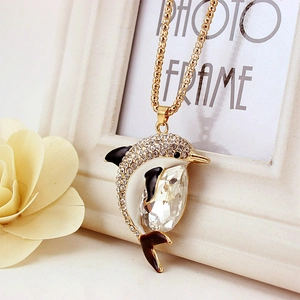 Golden dolphin necklace pendant with white crystals and large faceted central stone
