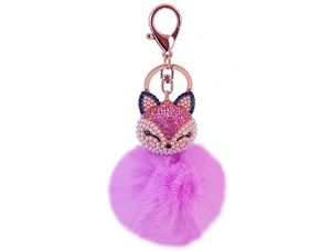 Detail of rose gold lobster clasp and purple faux fur pompom fox keychain