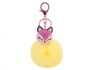 Detail of pink rhinestone fox head with white pearls and yellow faux fur pompom keychain