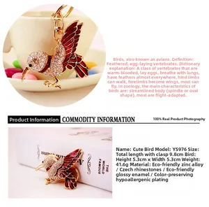 Detailed view of hummingbird keychain with red enamel wings and sparkling rhinestones