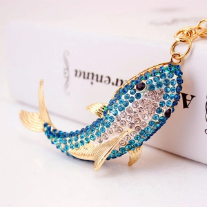 Sparkling crystal shark keychain with blue rhinestone gradient on a gold metal base