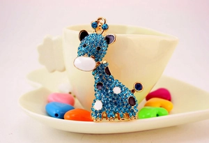 Détail du pendentif girafe avec strass bleus et finition en alliage plaqué or