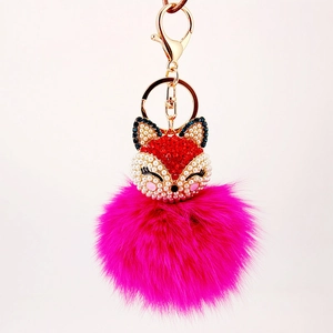 Cute fox keychain with red rhinestones and a fluffy magenta faux fur pompom ball