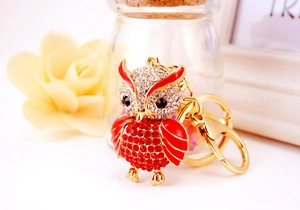 Detail of red and white crystals on golden owl keychain with sturdy lobster clasp