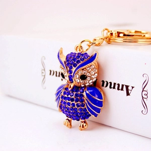 Exquisite owl keychain featuring blue enamel and sparkling crystals on golden metal plating