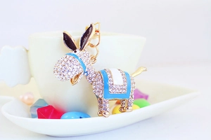 Detailed view of donkey keychain featuring white rhinestones and blue enamel details