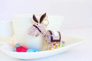 Close-up of sparkling rhinestone donkey keychain with elegant gold finish and enamel detail