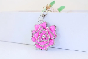 Macro shot of bright pink rose petal design keychain with white rhinestones and lobster clasp