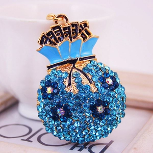 Porte-clés sac à monnaie en strass bleus avec cristaux et finition en métal doré
