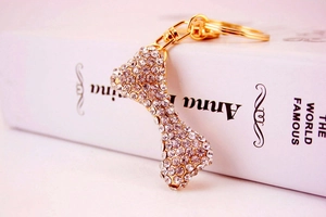Macro shot of gold bone keychain with shimmering rhinestones on vintage book