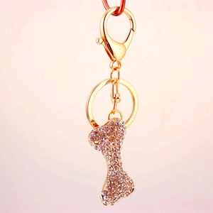 Golden bone-shaped keychain with sparkling crystals and lobster clasp accessory