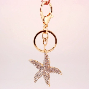 Sparkling starfish keychain with crystal rhinestones on a gold-plated metal ring