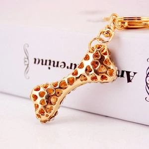 Golden bone-shaped keychain with heart hollow design and white rhinestones decoration