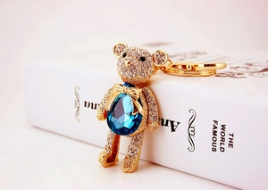 Close-up of crystal teddy bear keychain with sea blue teardrop stone and gold lobster clasp
