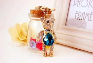 Detail of crystal teddy bear keychain with blue gemstone and gold lobster clasp
