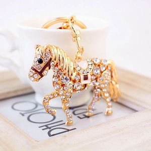 Porte-clés cheval doré étincelant avec strass blancs et anneau en métal poli brillant