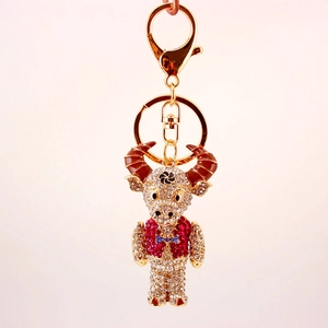 Detailed view of ox keychain featuring sparkling red and white rhinestones and gold plating