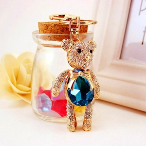 Sparkling crystal bear keychain with deep blue gemstone and gold-tone metal hardware