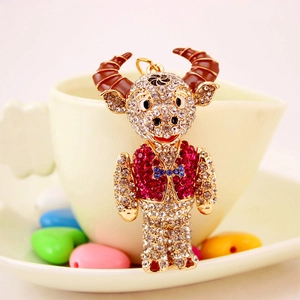 Sparkling crystal zodiac ox keychain with white and pink rhinestones on gold metal base
