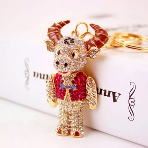 Sparkling rhinestone ox keychain with gold-plated alloy finish and crystal embellishments