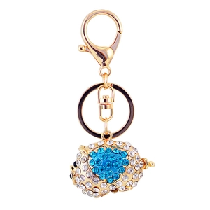 Charming pig keychain with blue and white crystals on golden alloy base with lobster clasp
