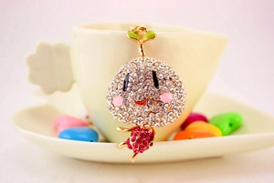 Vue macro du pendentif de germe serti de strass brillants sur une tasse de café