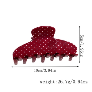 Dettaglio della grande pinza per capelli rossa a pois, misura 10cm e peso 26,7g