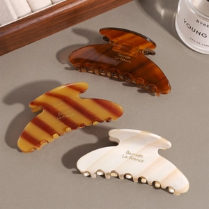 Vintage acetate hair claws in tortoise shell, amber, and marble finishes for women