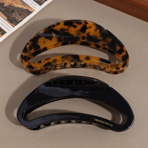 Set of two vintage acetate moon-shaped hair claws in tortoiseshell and black finish