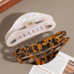 Elegant large acetate crescent hair claws in pearlescent white and tortoiseshell pattern