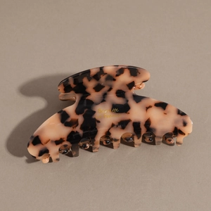 Detail view of acetate tortoise shell hair claw clip with gold Barrette La France text