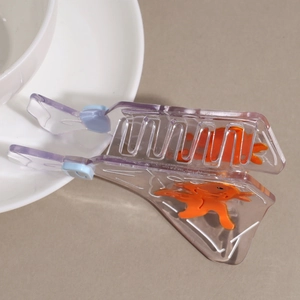 Transparent purple shark hair claw clip with floating orange goldfish detail accessory