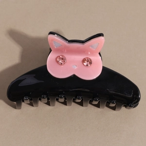 Detail shot of a black acetate cat hair claw clip with pink ears and sparkling rhinestones
