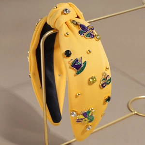 Serre-tête jaune noué avec breloques émaillées Mardi Gras et strass colorés sur support doré