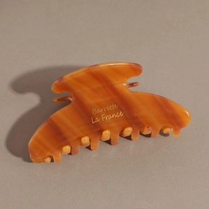 Detail of amber tortoiseshell hair claw with gold Barrette La France lettering