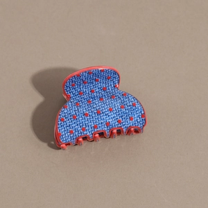 Detail of denim texture hair claw clip with red polka dots and durable resin teeth