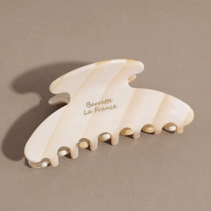 Detail of cream marble acetate hair claw clip with Barrette La France lettering