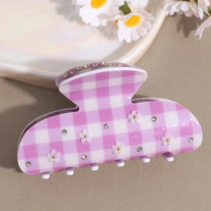 Detail of pink plaid hair claw with 3D white flowers and sparkling rhinestones inlay
