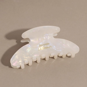 Close-up of marble acetate hair claw clip with golden Barrette La France lettering