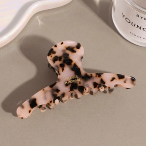 Detail of pink tortoiseshell acetate hair claw with gold France Handmade logo