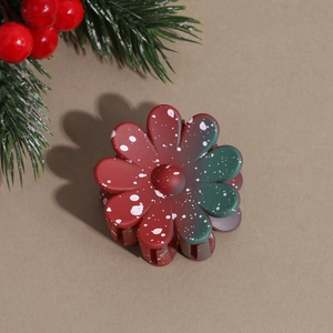 Detail of Christmas flower hair claw clip with red and green gradient and snow effect