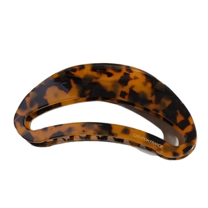 Vintage crescent acetate hair claw clip with tortoiseshell leopard pattern on white background