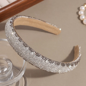 Detail view of full rhinestone headband with silver and grey crystals on velvet lining