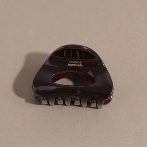 Detail view of tortoiseshell acetate hair claw with gold France Handmade lettering